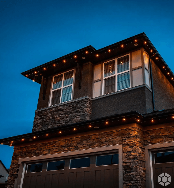 A house with a lot of windows is lit up at night