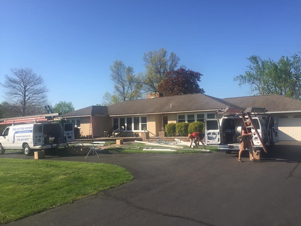 A house with two vans parked in front of it.