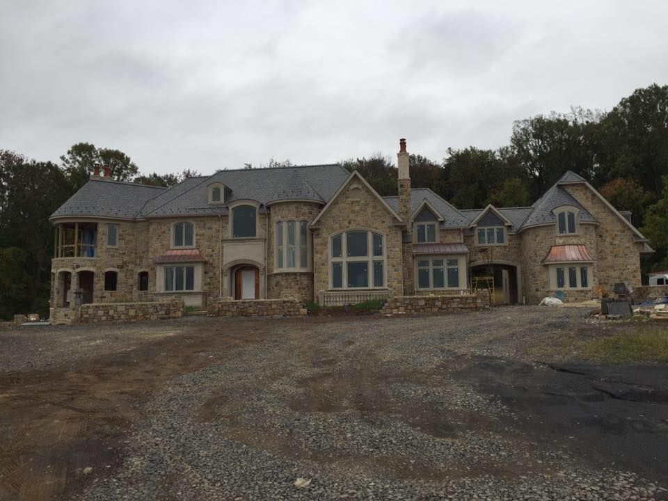 A large house with a lot of windows is being built