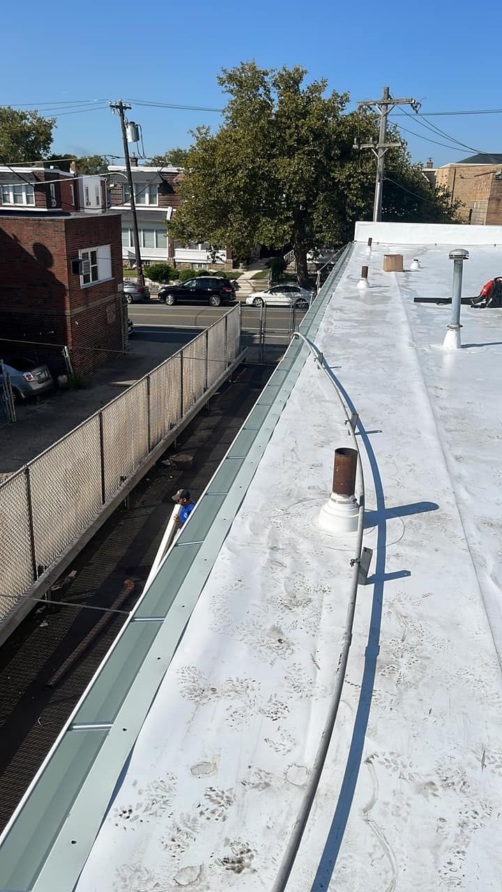A white roof with a chimney on top of it.