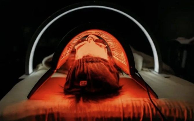 A person in a light therapy treatment bed.