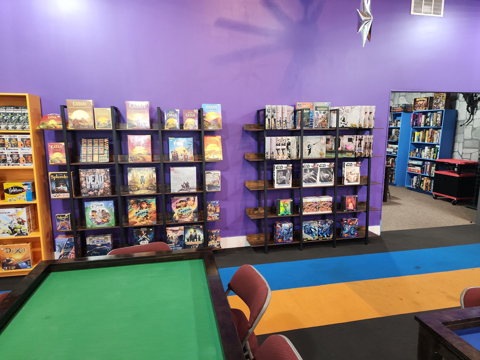 Room with a table and shelves filled with board games
