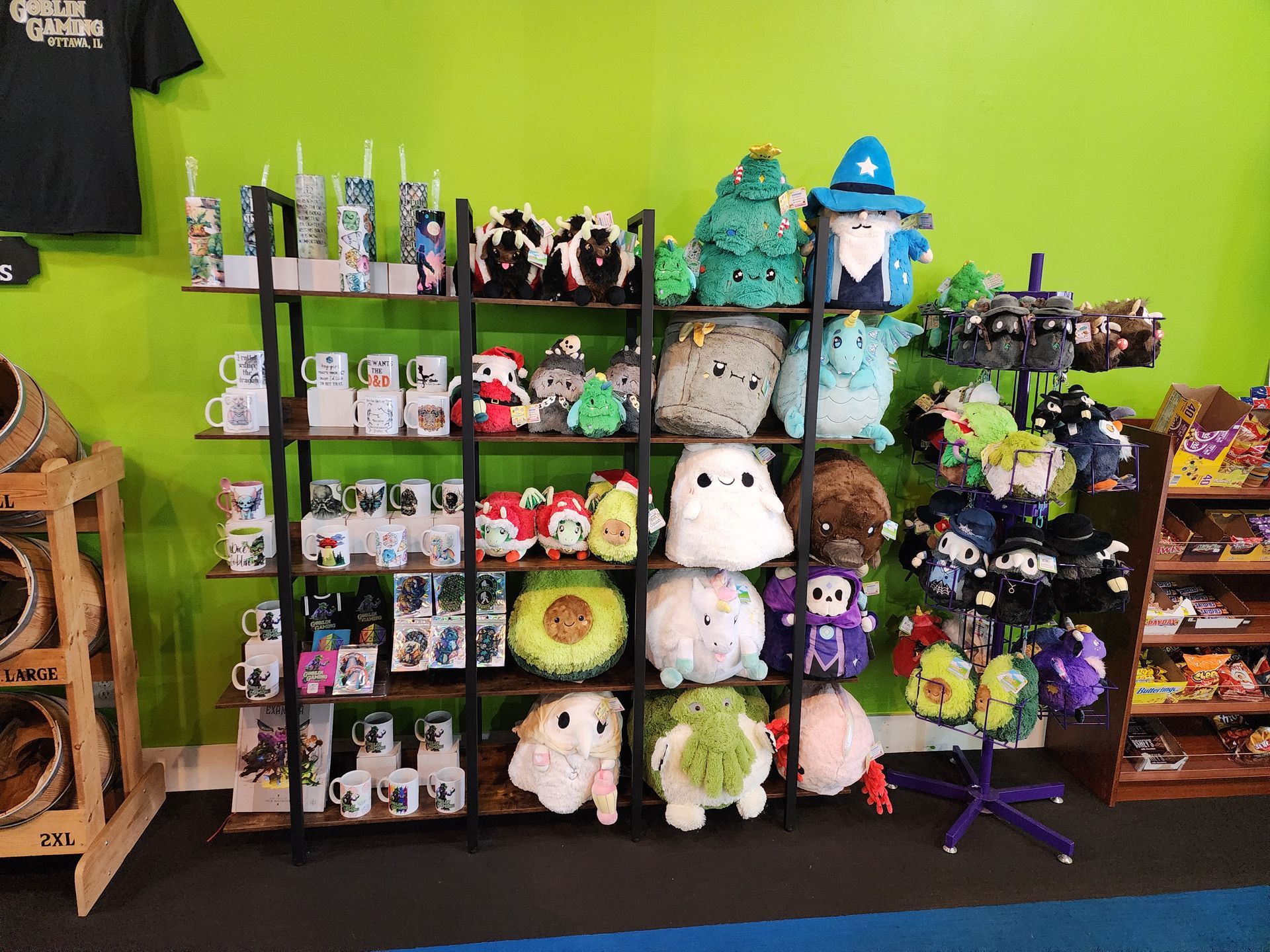 A shelf filled with stuffed animals and mugs in a store
