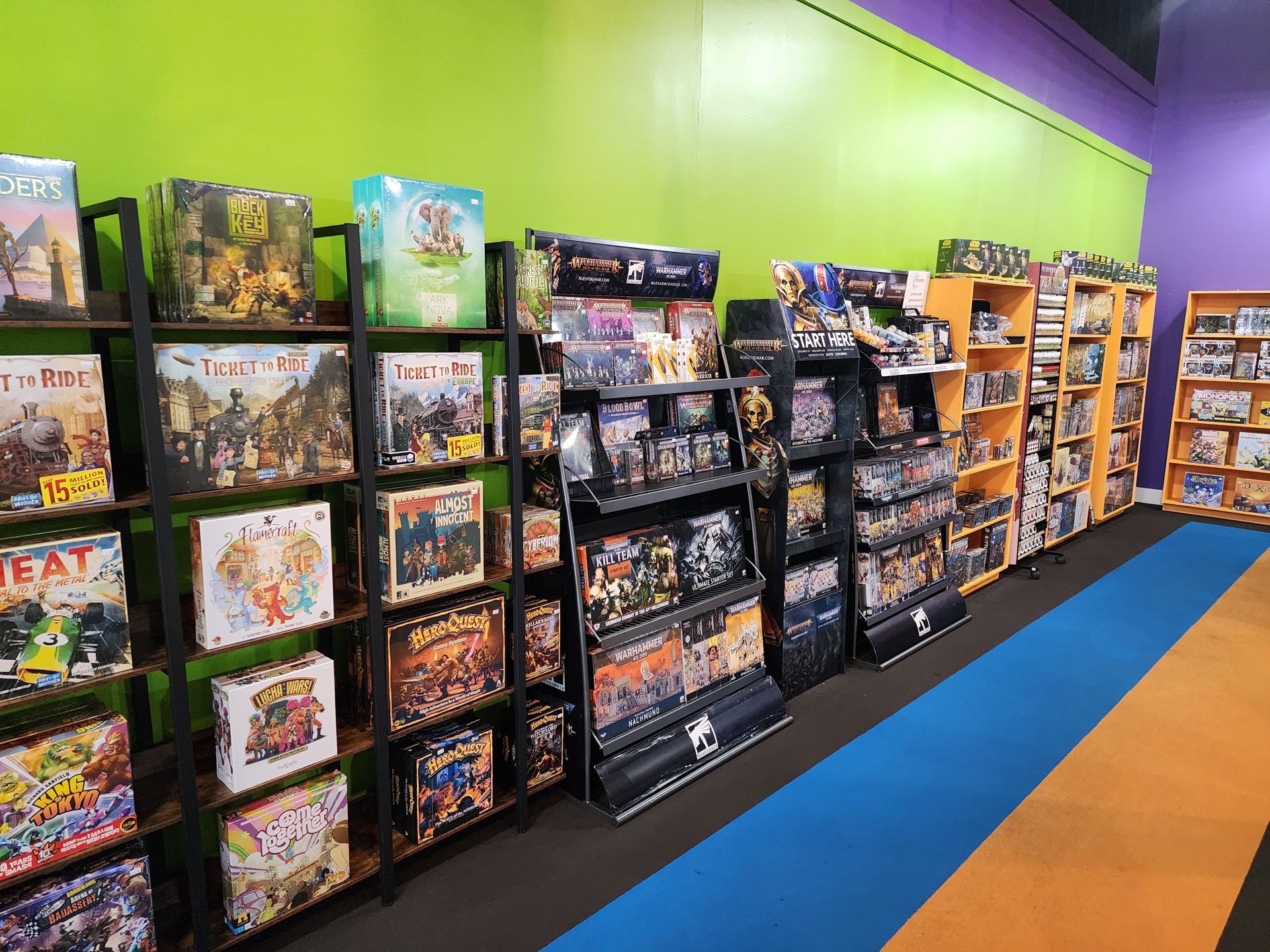 A row of shelves filled with lots of board games in a store