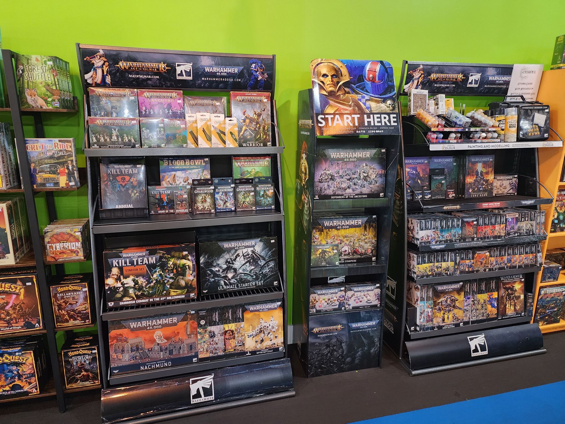 A display of games in a store with a sign that says start here