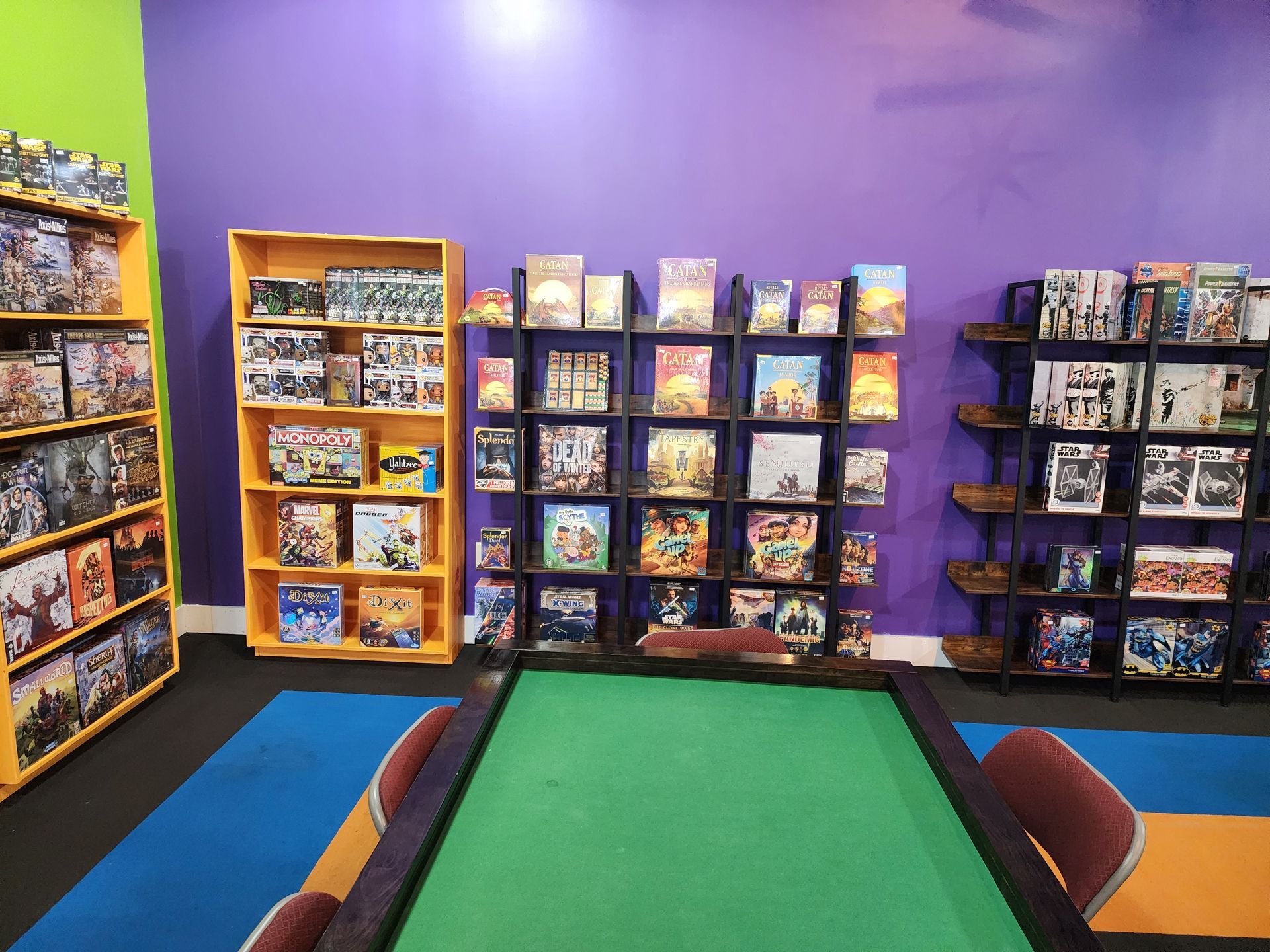 A room with a table and shelves filled with board games