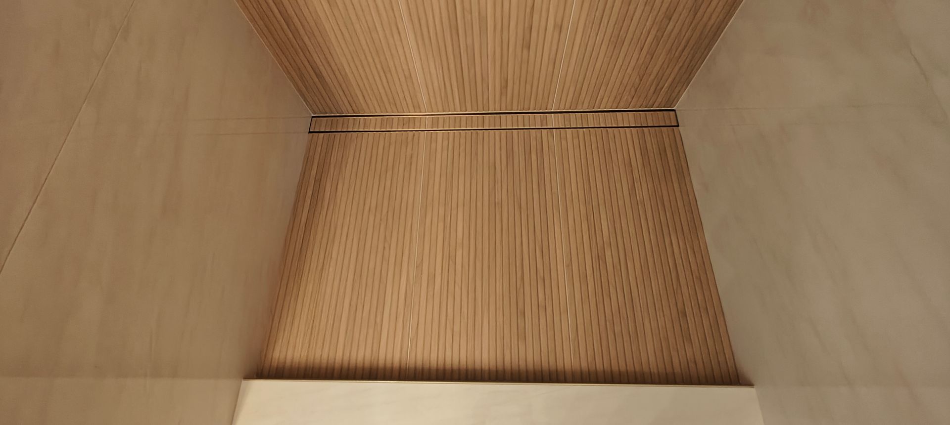Empty wooden cabinet interior with a woven bamboo back panel.