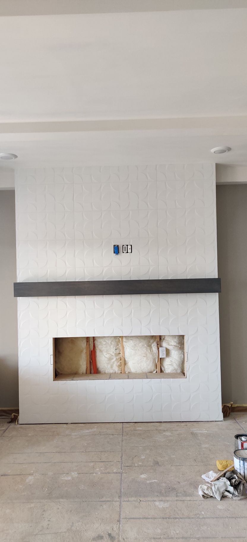 Empty white wall with a narrow horizontal fireplace opening and a gray band across the center.
