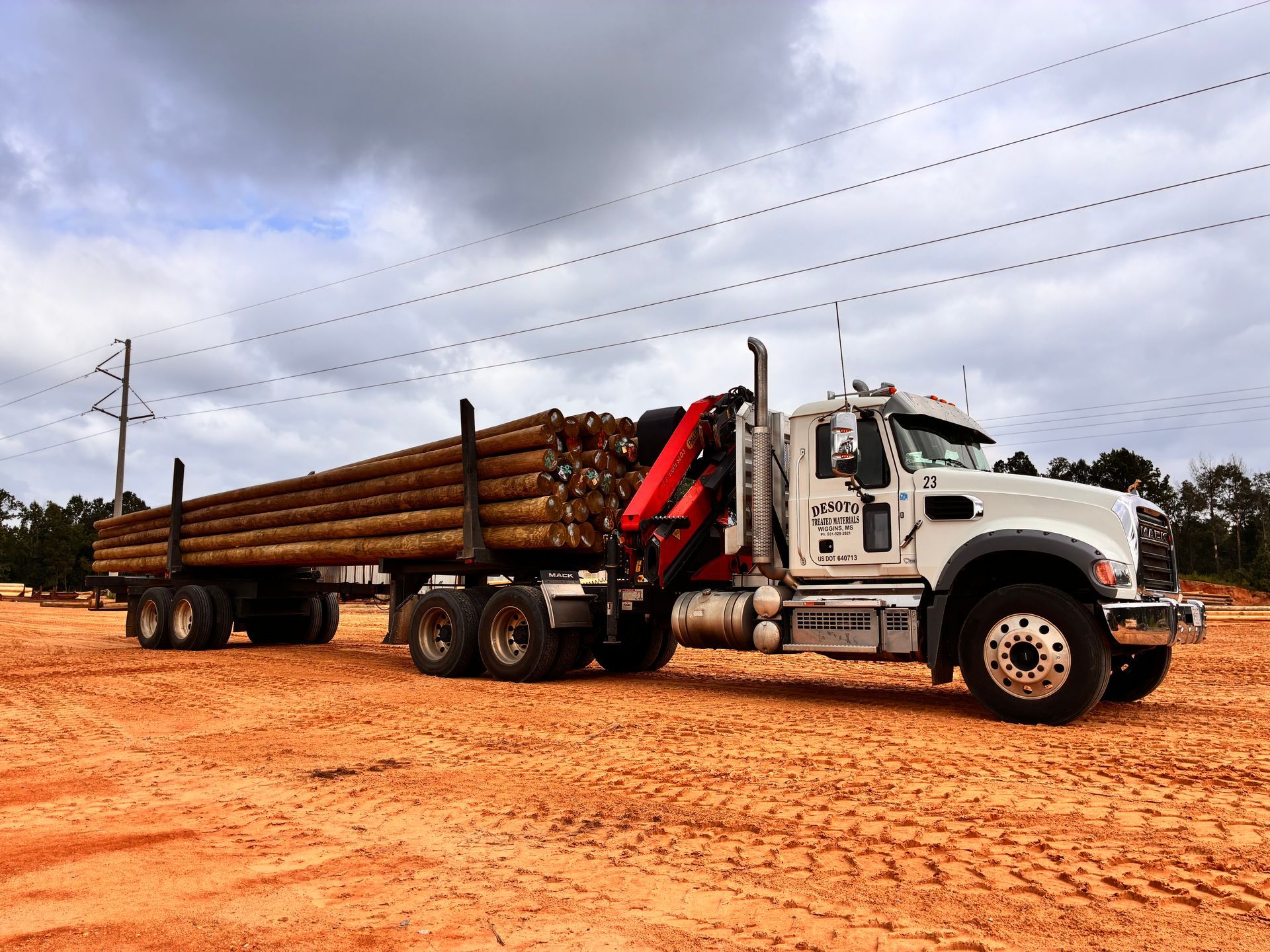 Construction site in a harbor, with a bridge in the background and a crane on the right.