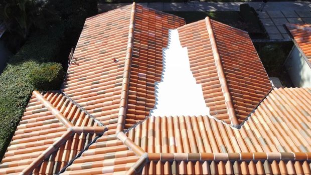 Terracotta-tiled roof with a white skylight or roof gap running down the center
