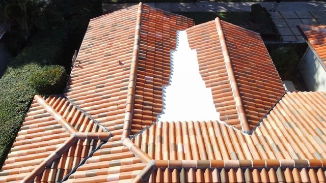 Terracotta-tiled roof with a white skylight or roof gap running down the center