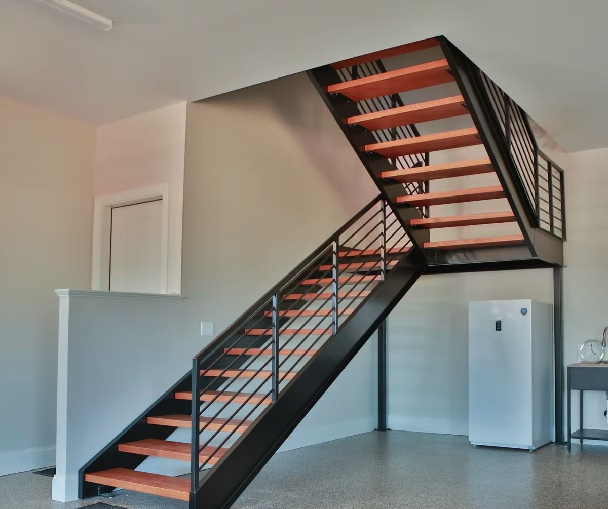 Modern staircase with black metal frame and wooden steps, leading upwards.