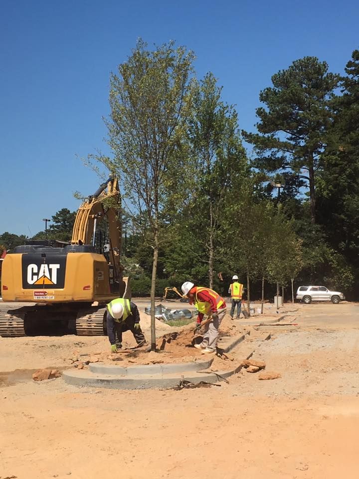 A construction site with a cat excavator in the background