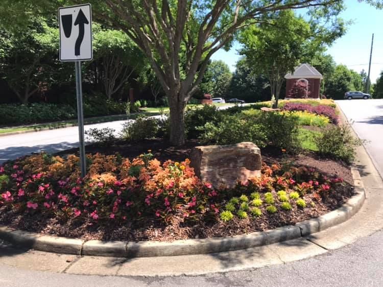 A roundabout with flowers and a sign that says right turn