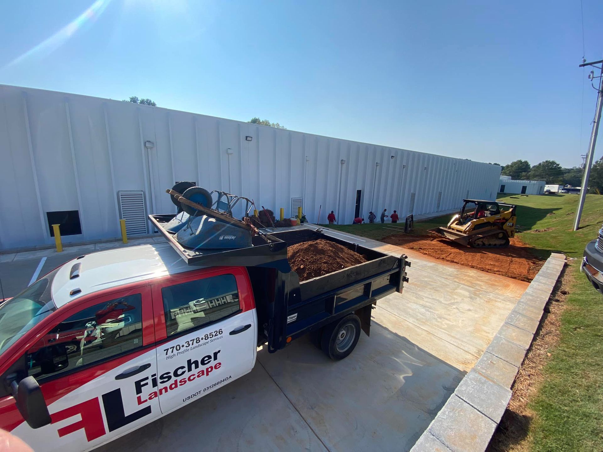 A red and white truck is parked in front of a building.
