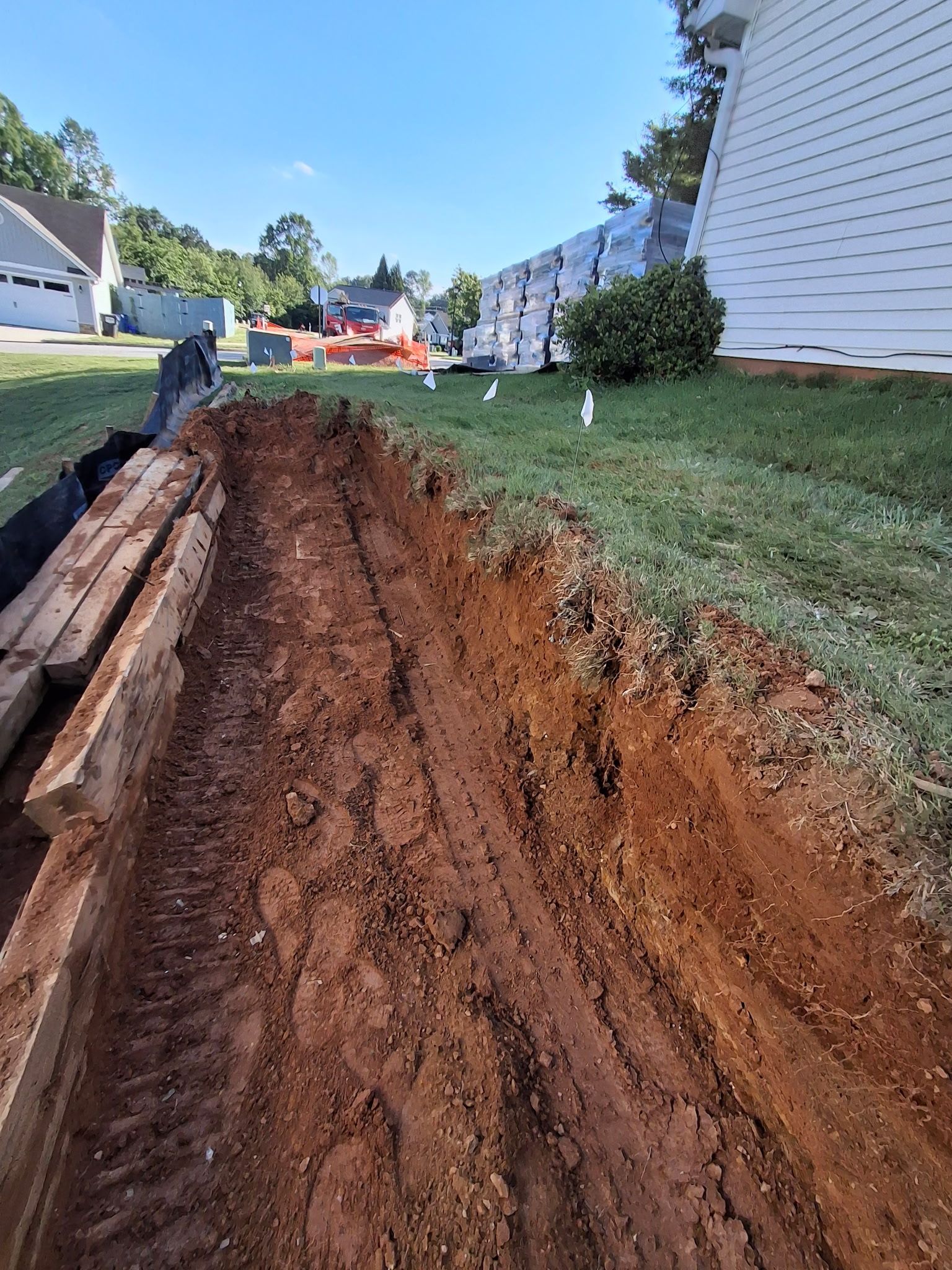 A large pile of dirt is sitting in front of a house.