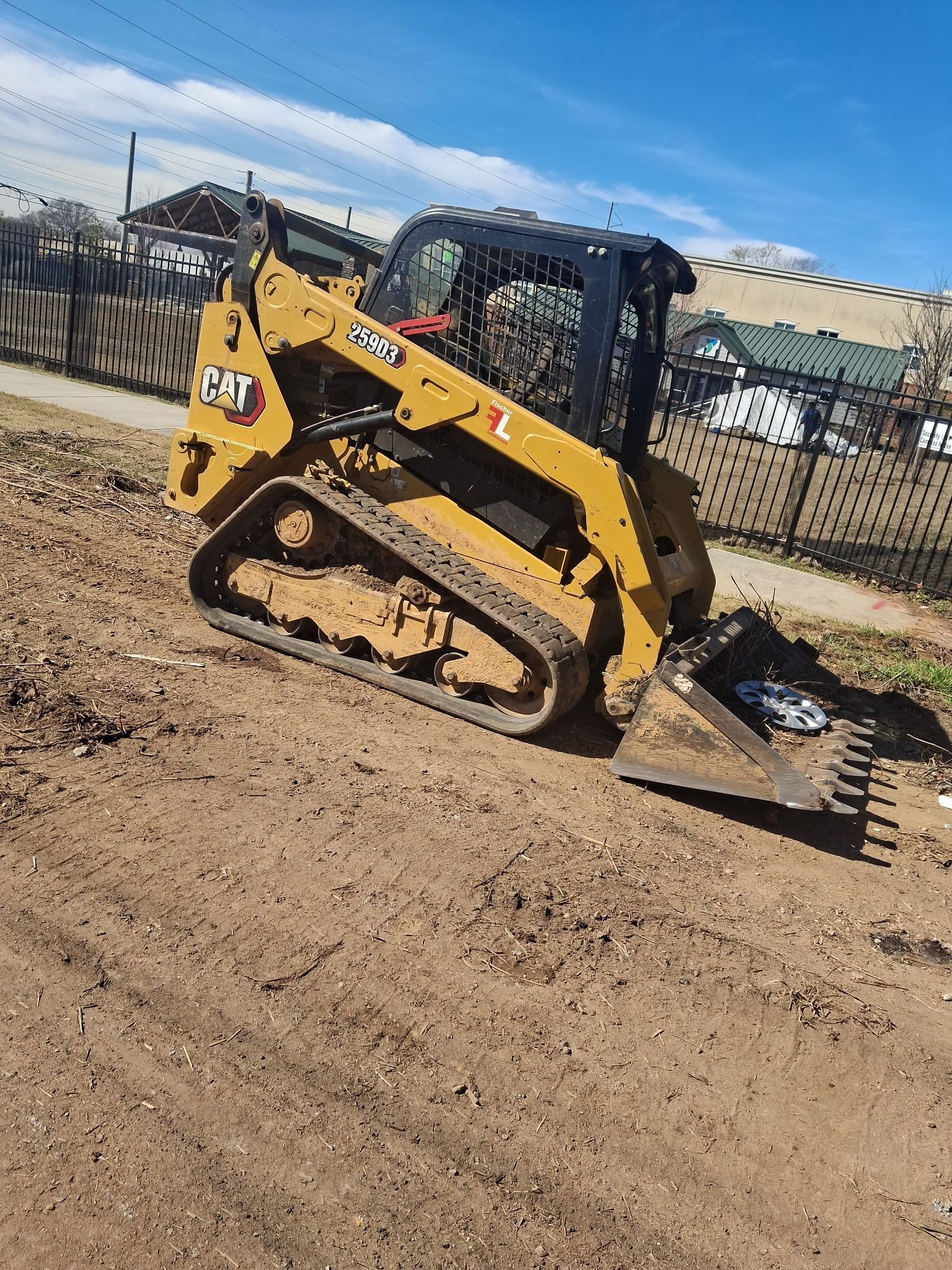 A bulldozer is sitting on top of a dirt hill.