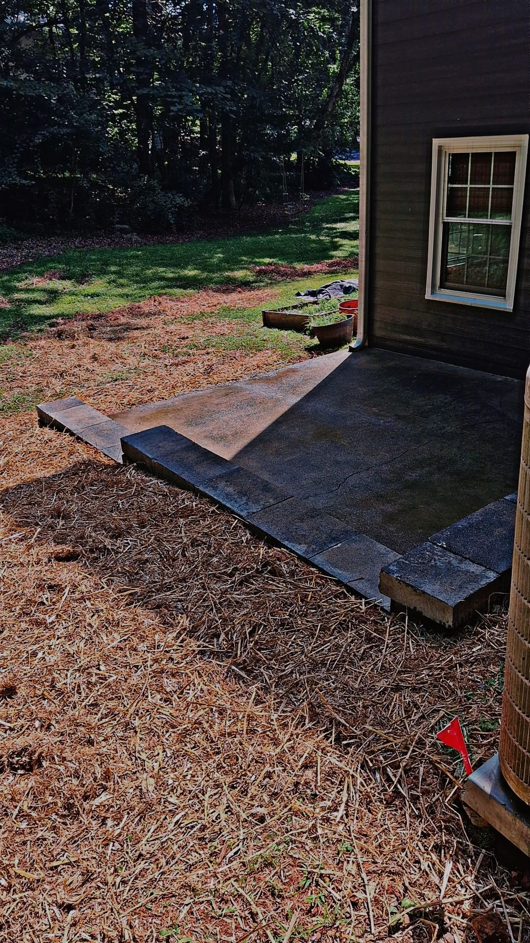 A house with a patio and stairs in front of it.