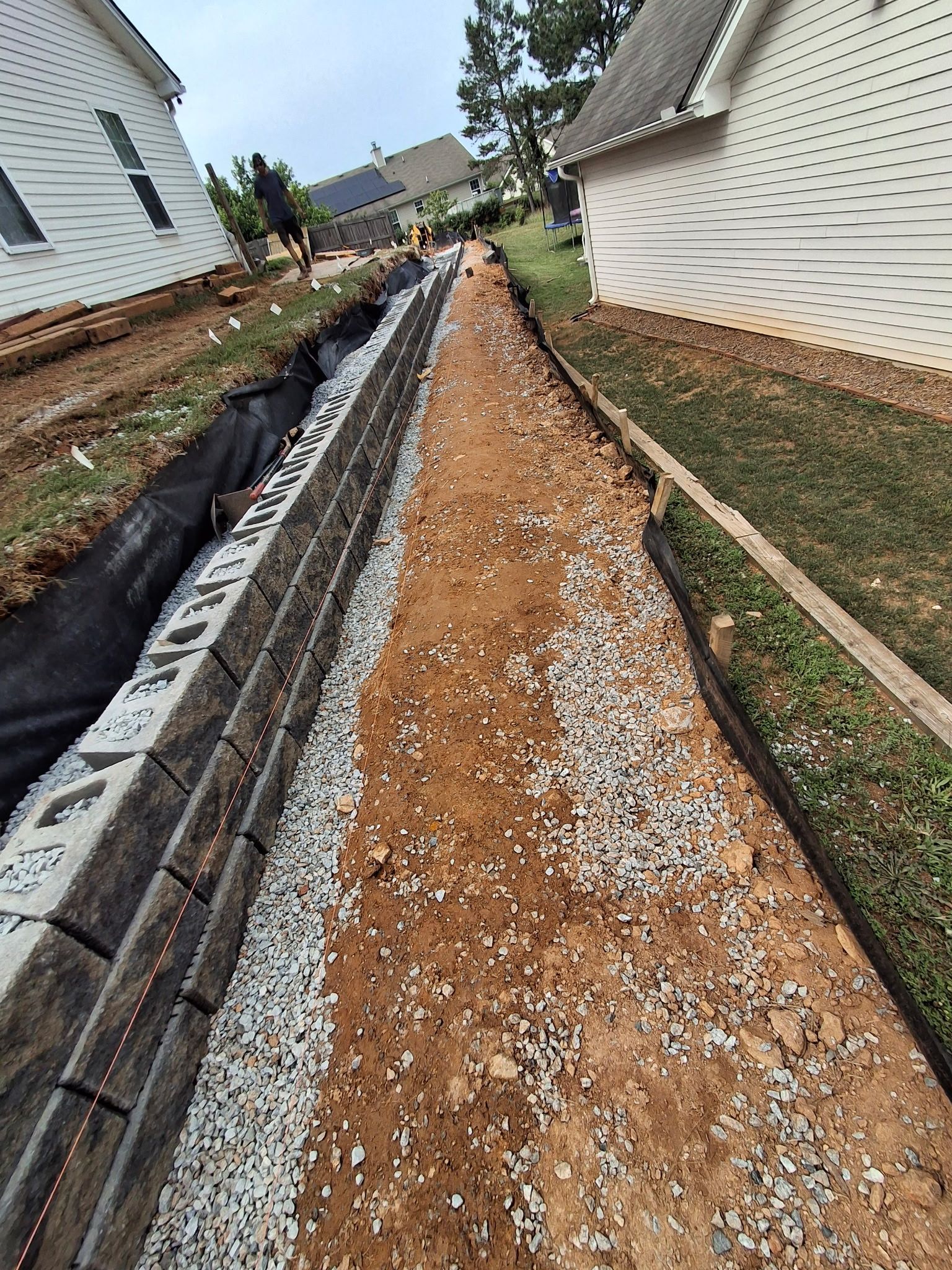 A dirt road is being built in front of a house.