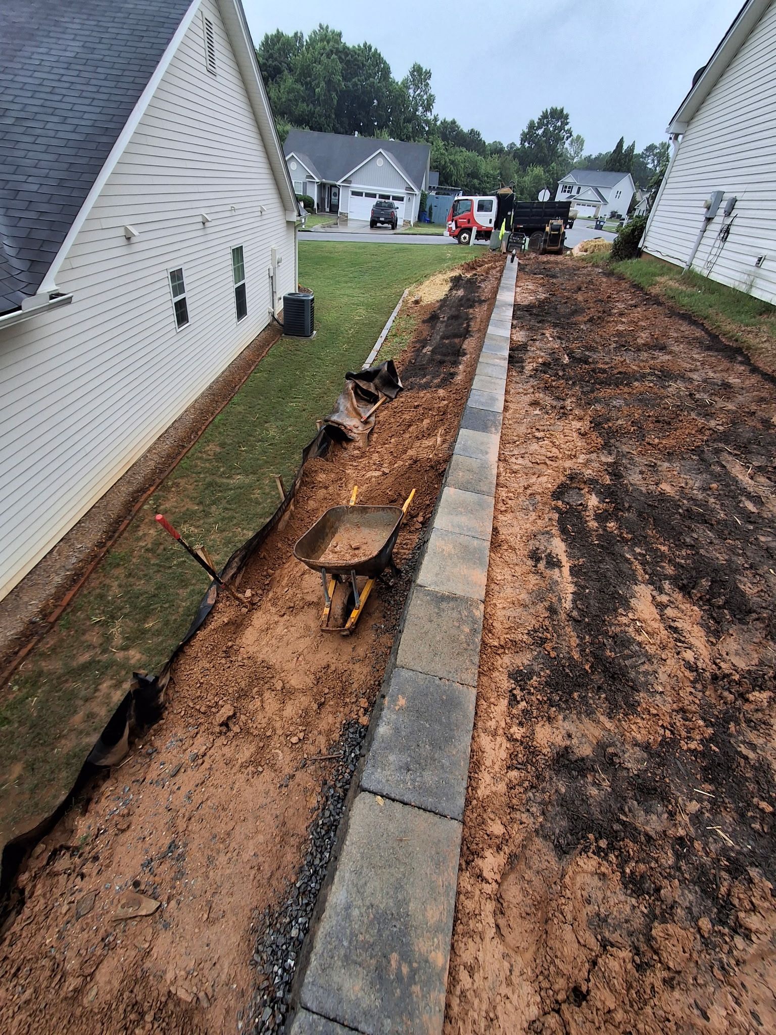 A sidewalk is being built in front of a house.