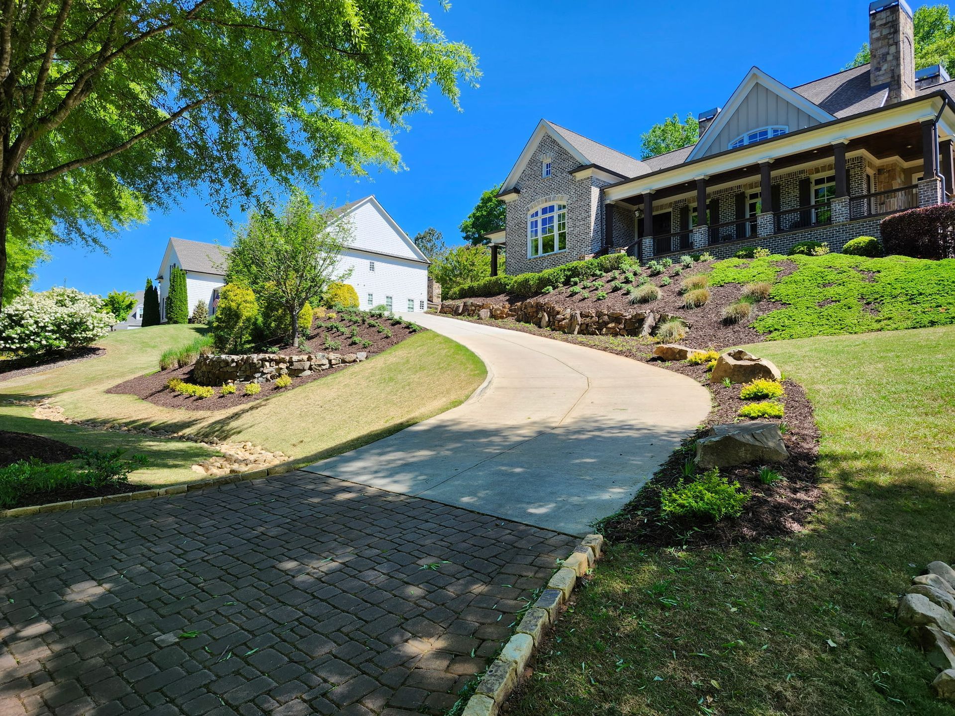 A large house with a long driveway leading to it.