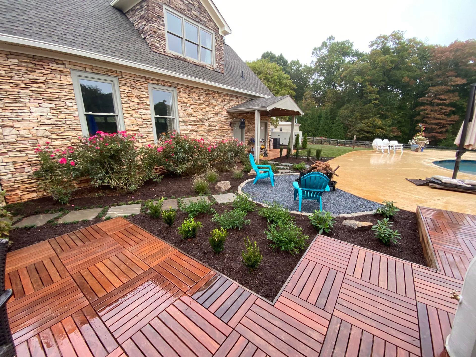 A large brick house with a wooden deck in front of it.