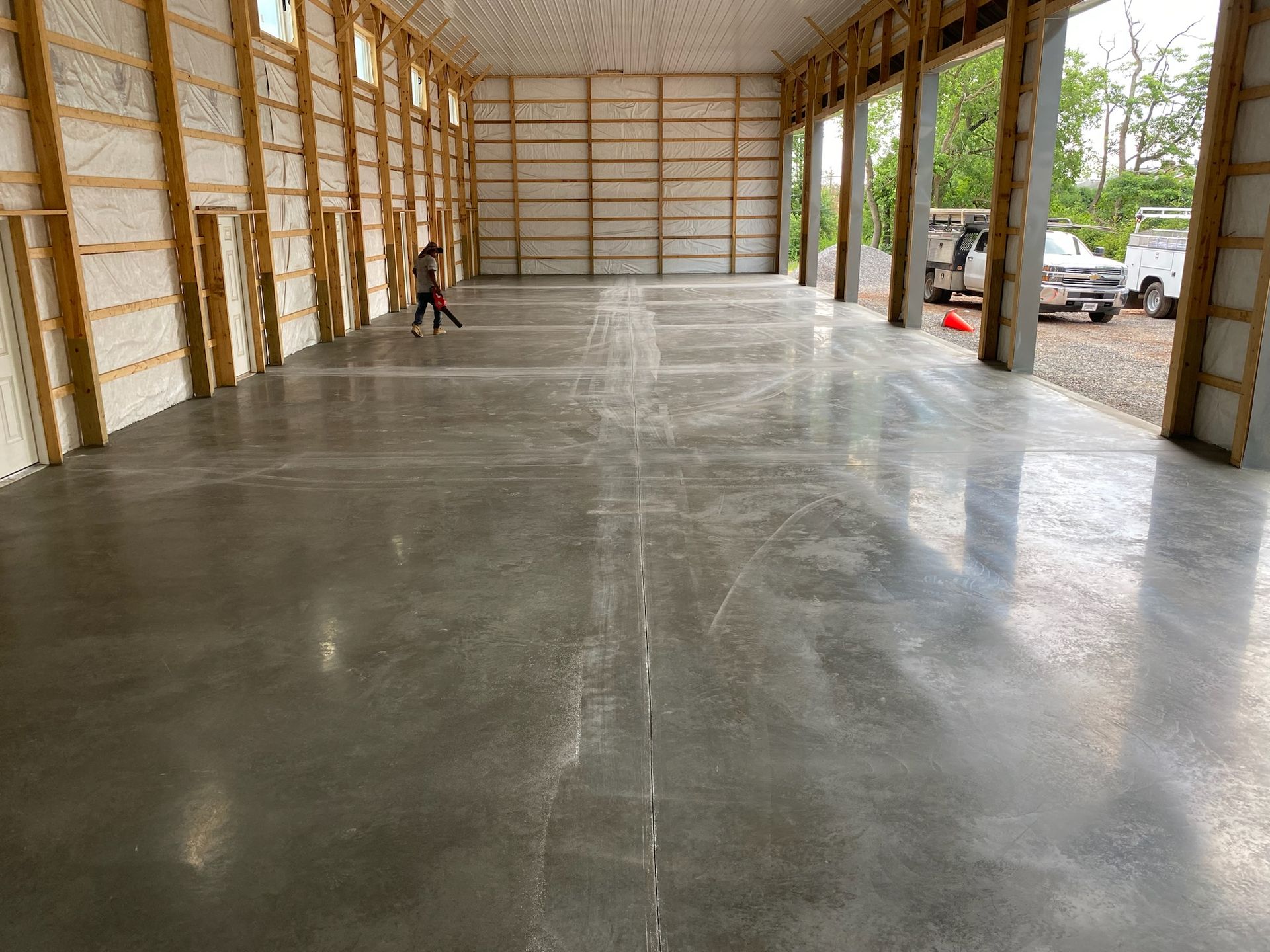 a man is walking through a large warehouse with a concrete floor