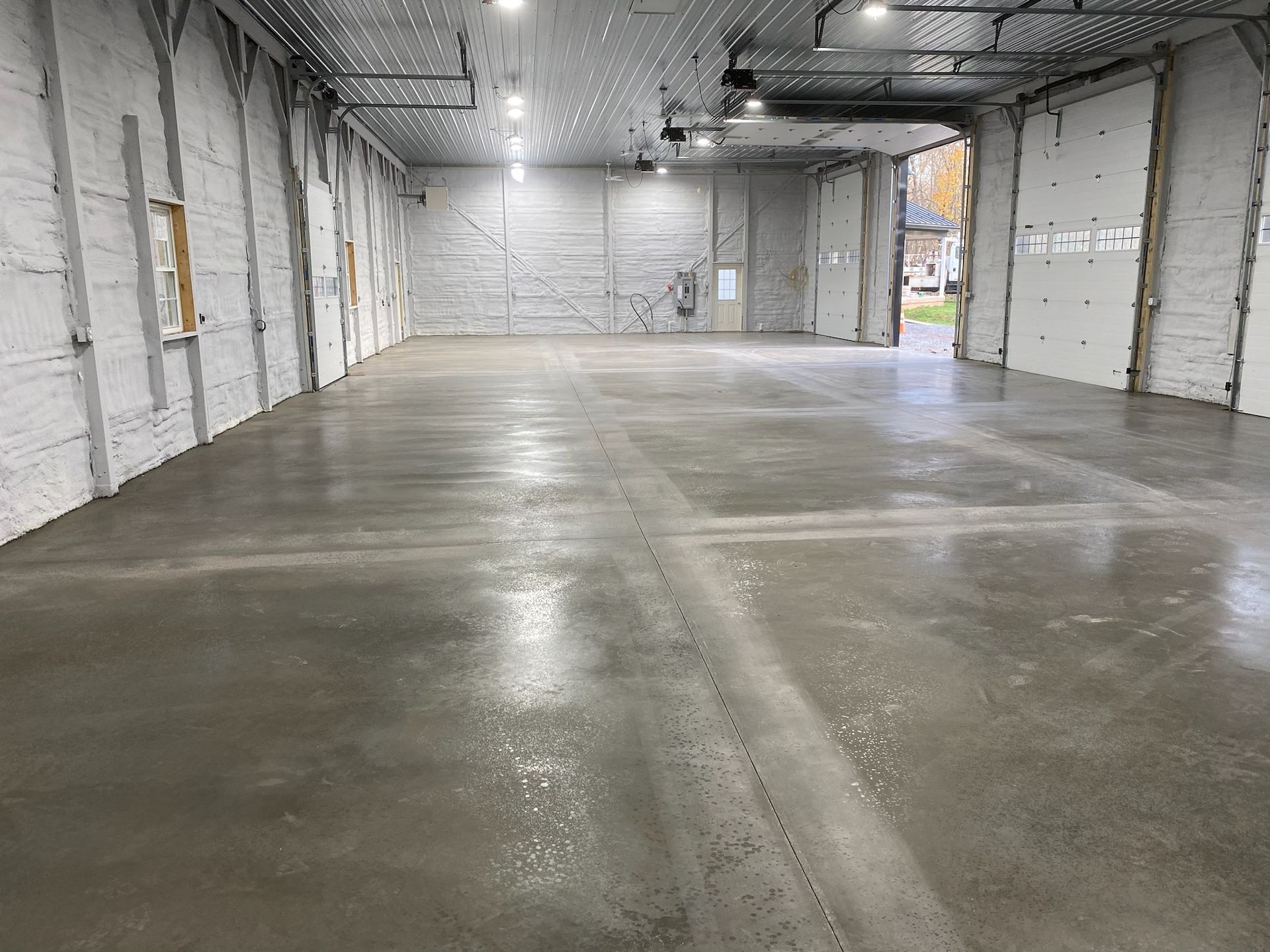 a large warehouse with a concrete floor and white walls