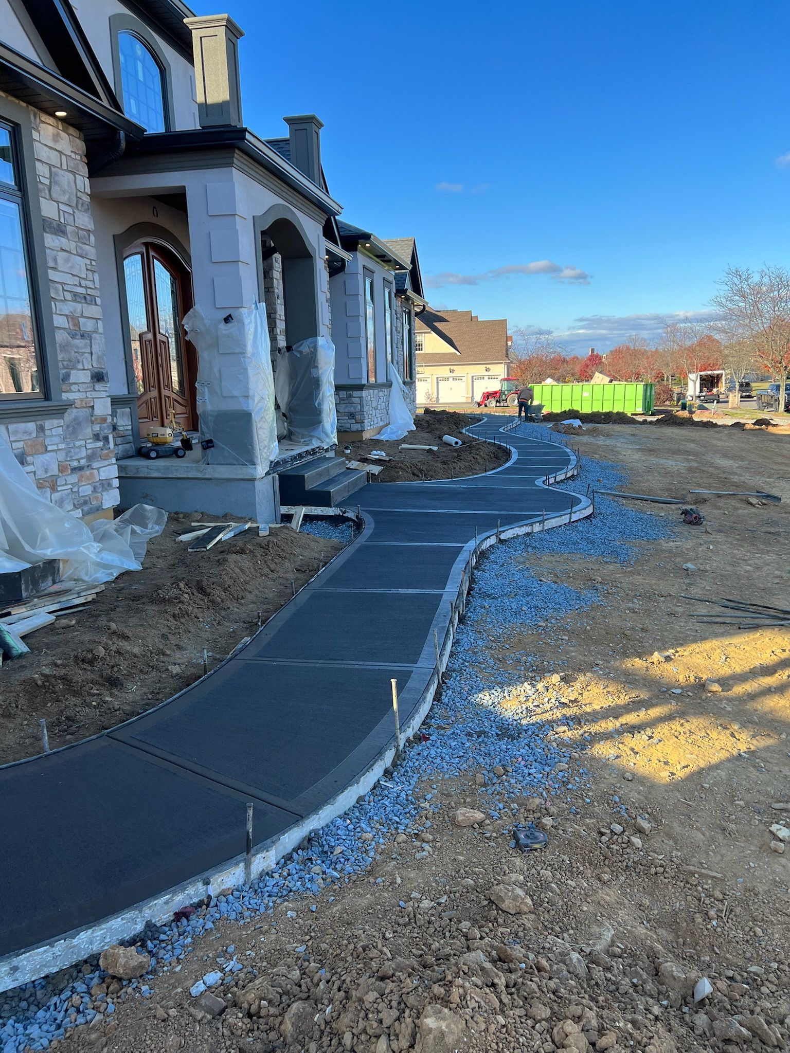 a concrete walkway is being built in front of a house