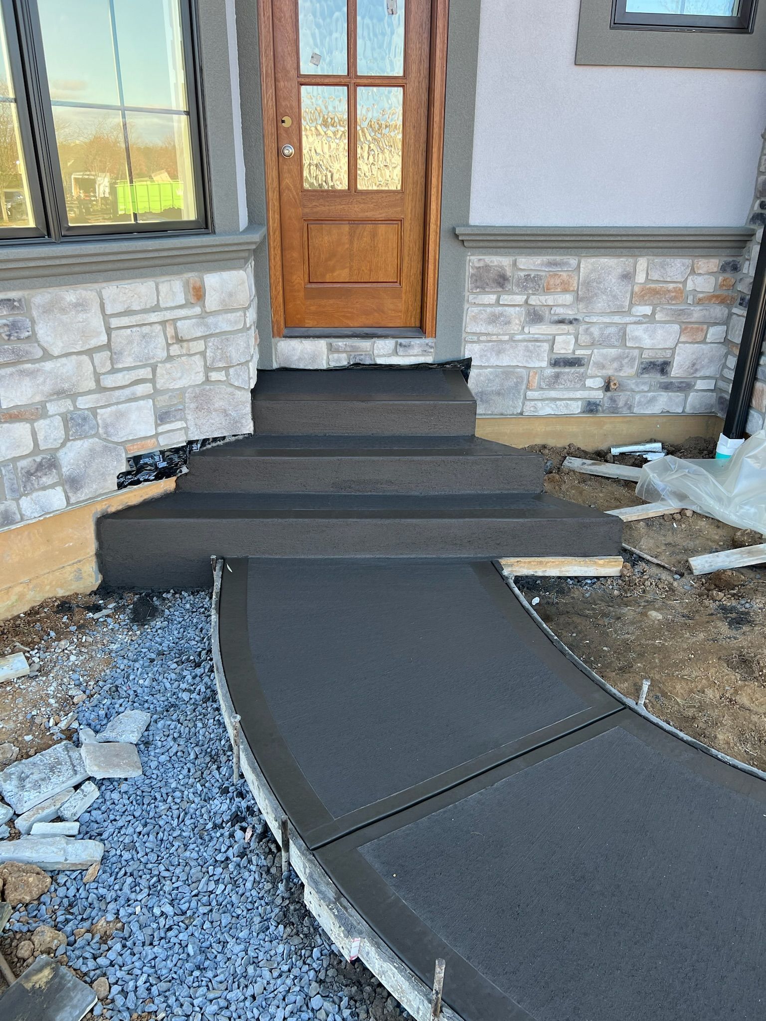 a concrete walkway leading to the front door of a house
