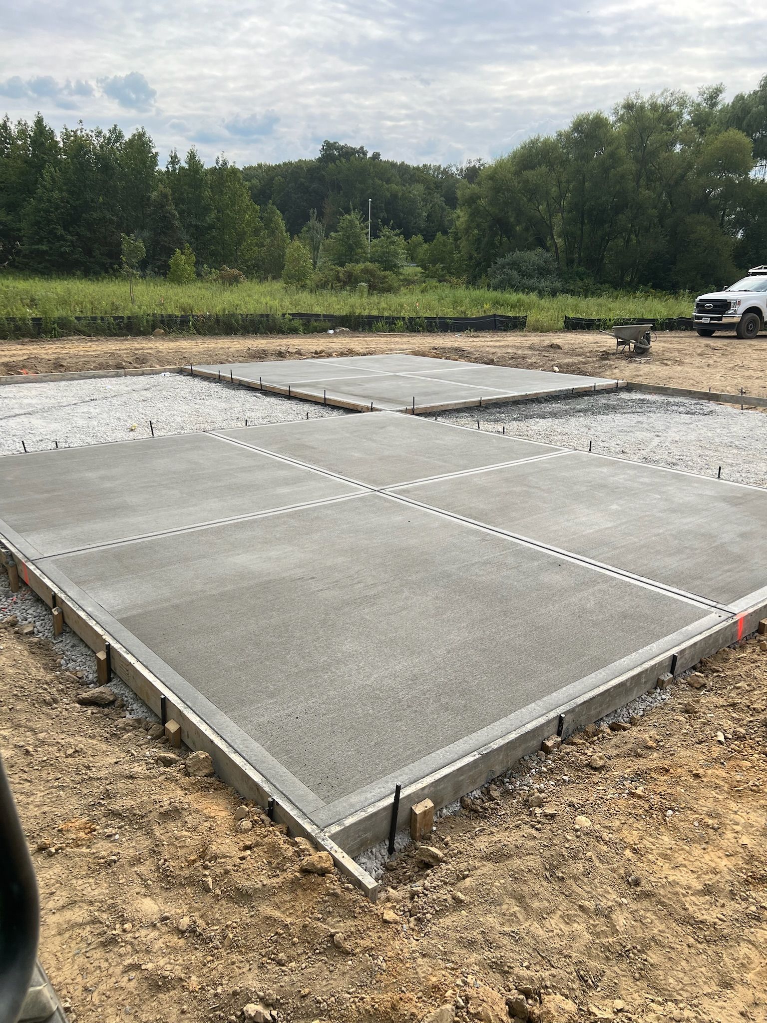 a concrete floor is being built in a dirt field