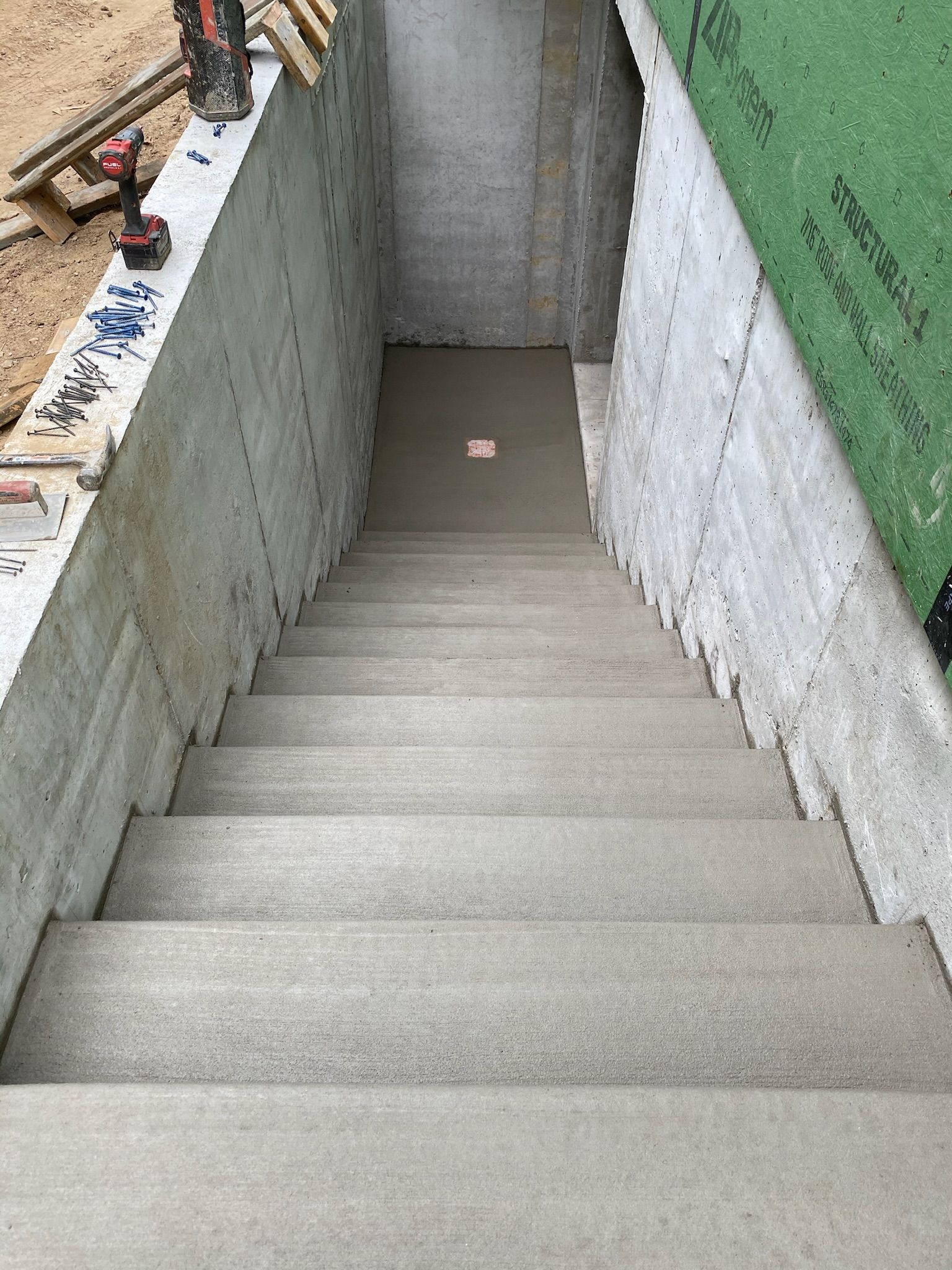 a set of concrete stairs leading up to a basement under construction