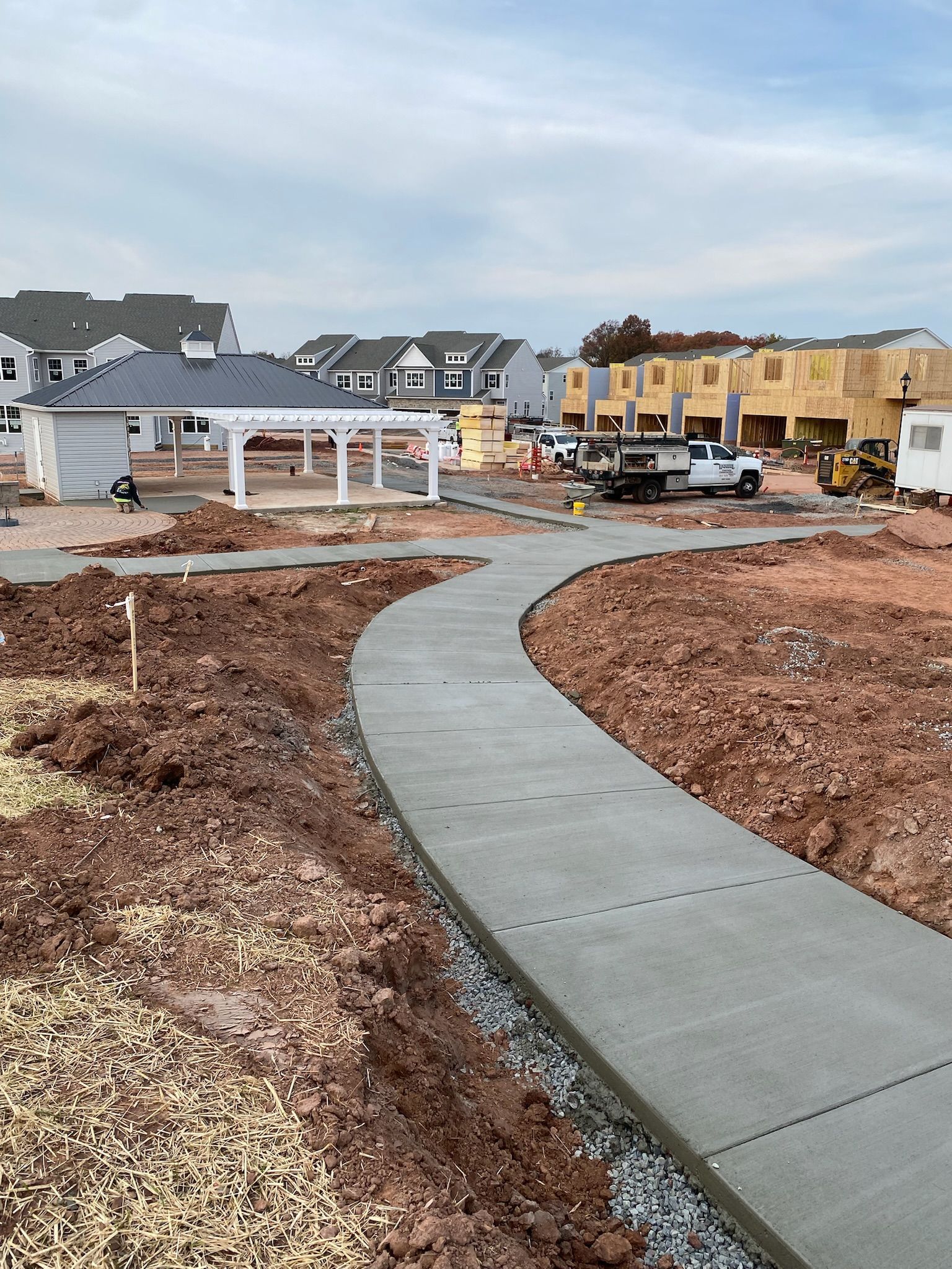 a concrete walkway is going through a dirt field