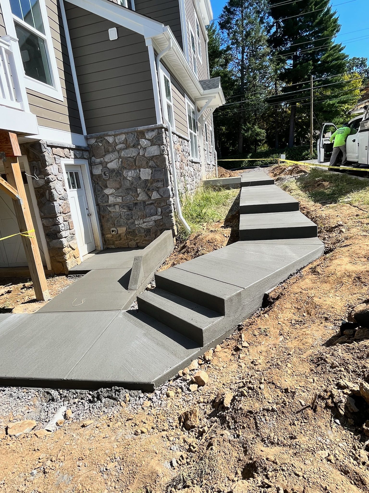 a concrete walkway is being built in front of a house