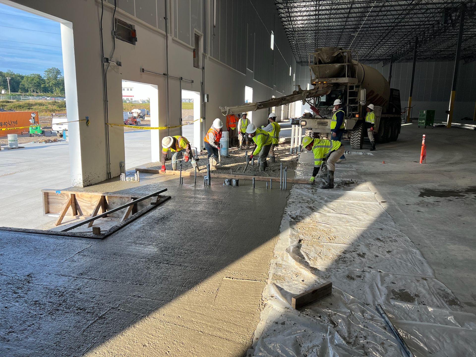 a group of construction workers are working on the floor of a building