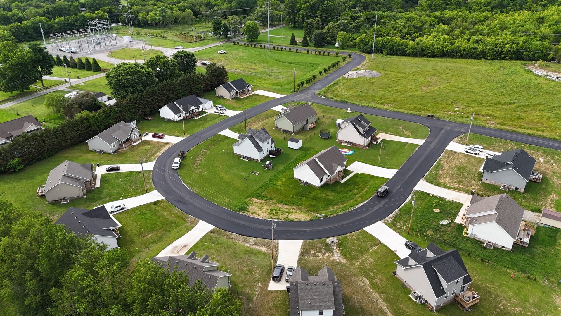 An aerial view of a residential area with houses and a road.