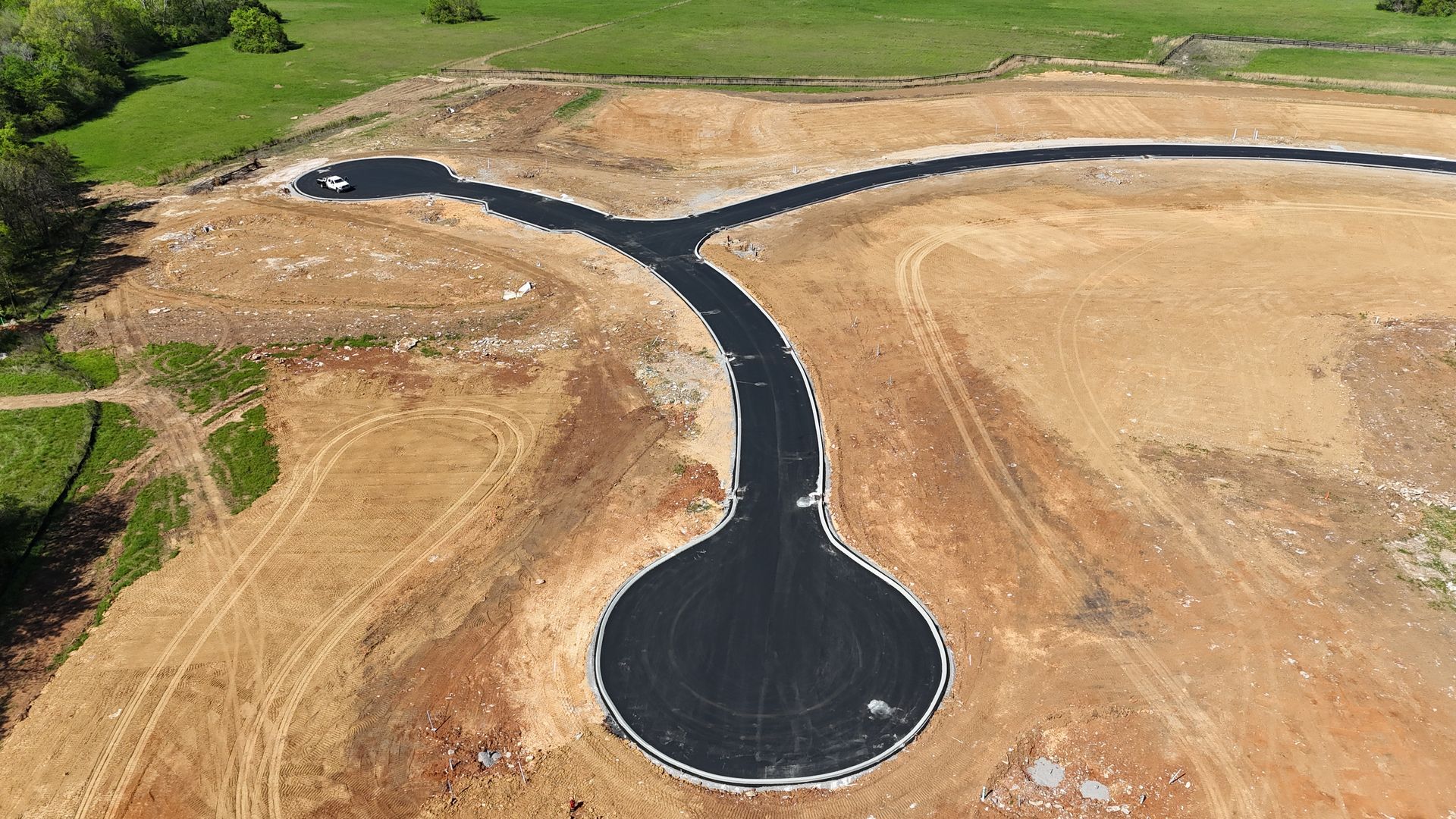 An aerial view of a road that is being built in a field.