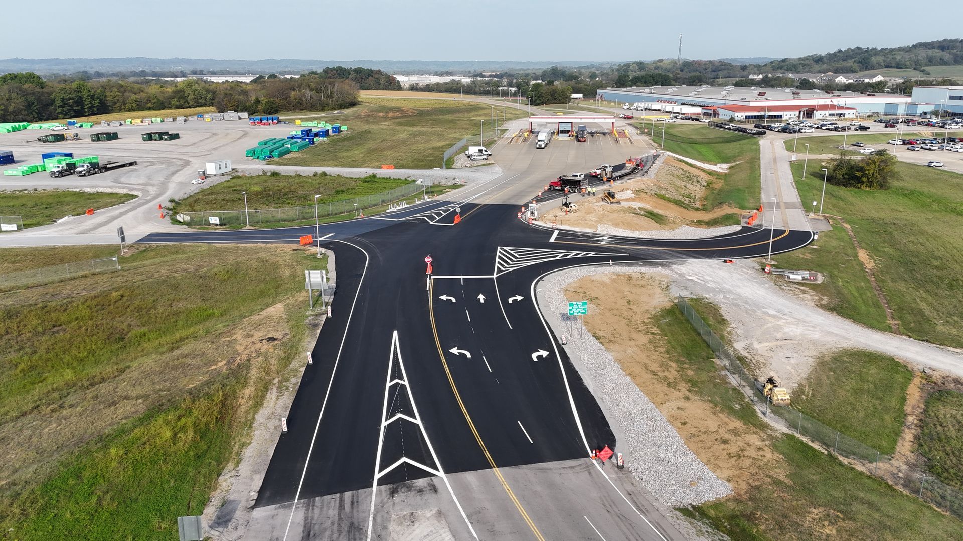 An aerial view of a newly paved road in a rural area.