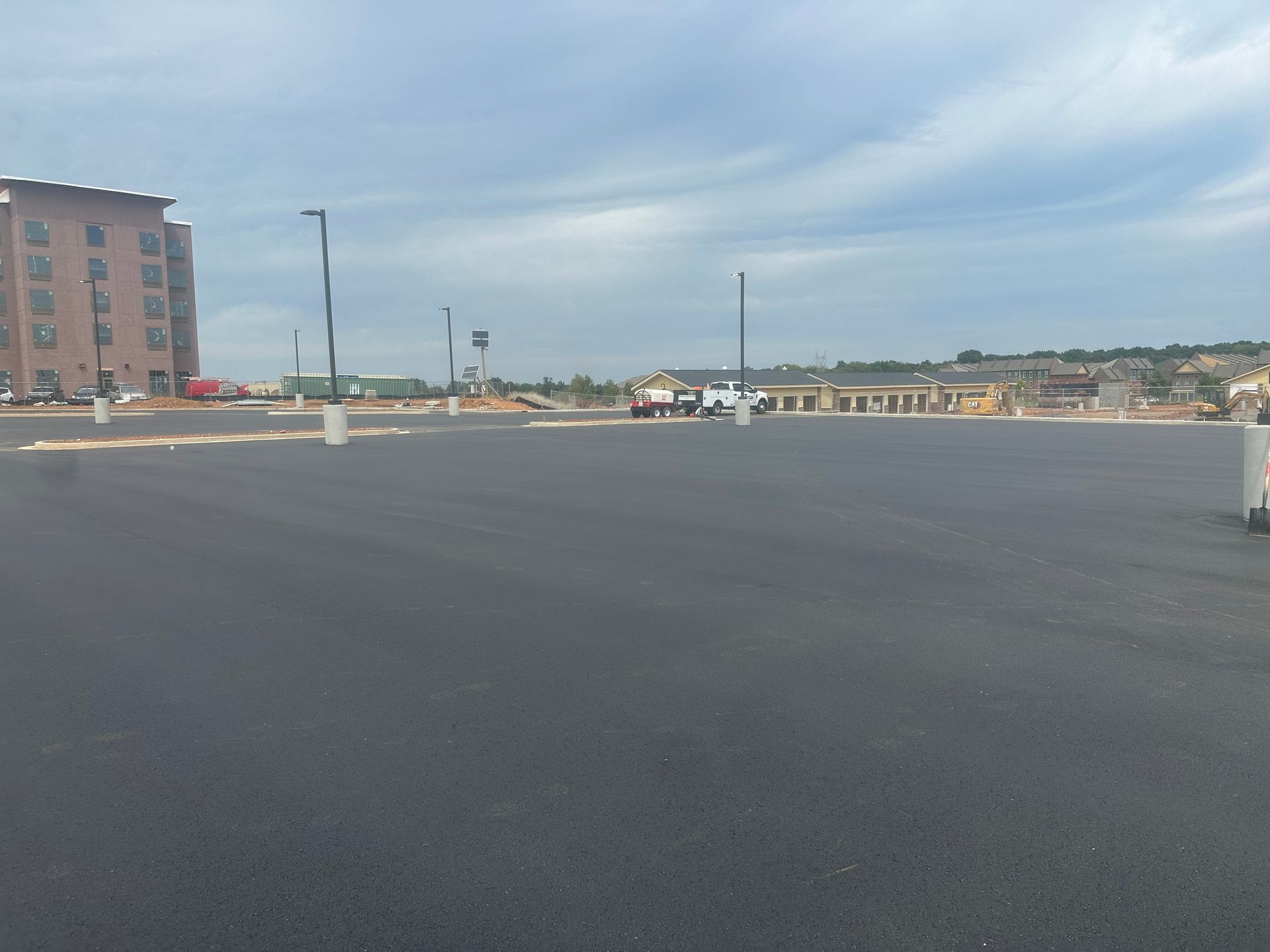 An empty parking lot with a building in the background.