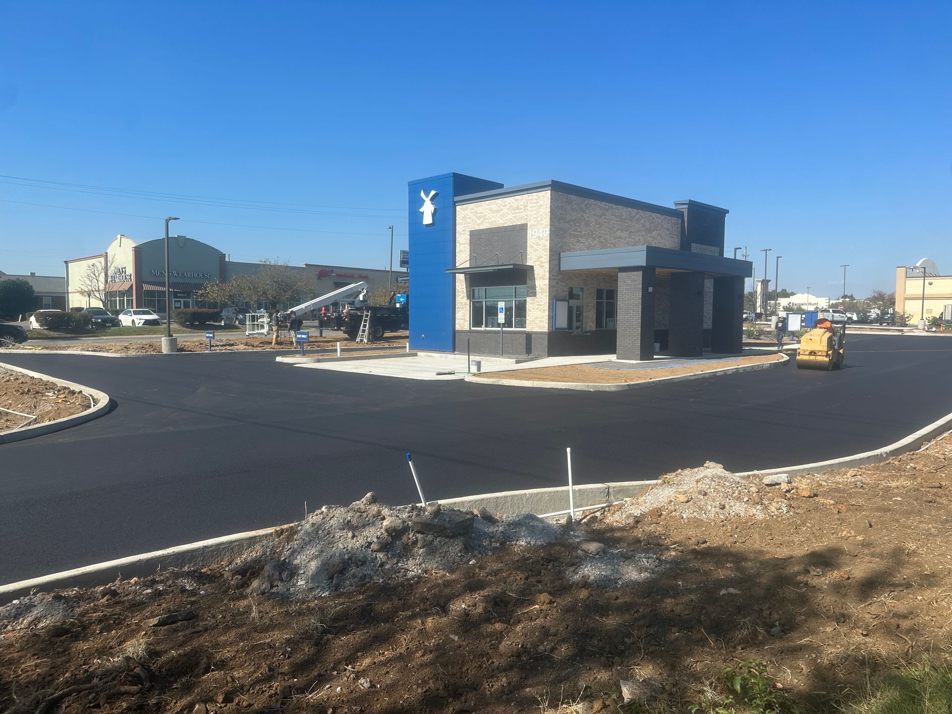 A blue and white building with a goat on it is being built.