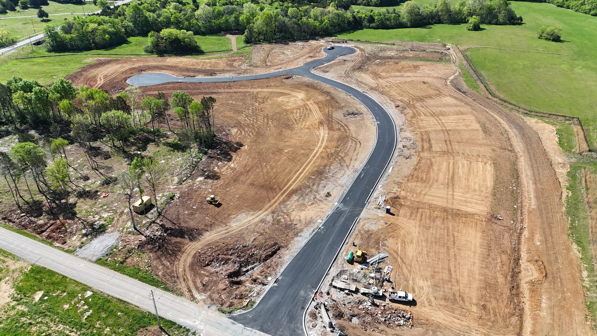 An aerial view of a construction site with a road going through it.