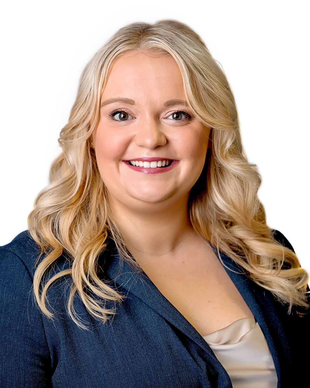 Woman with wavy blonde hair, smiling, wearing a dark blue blazer.