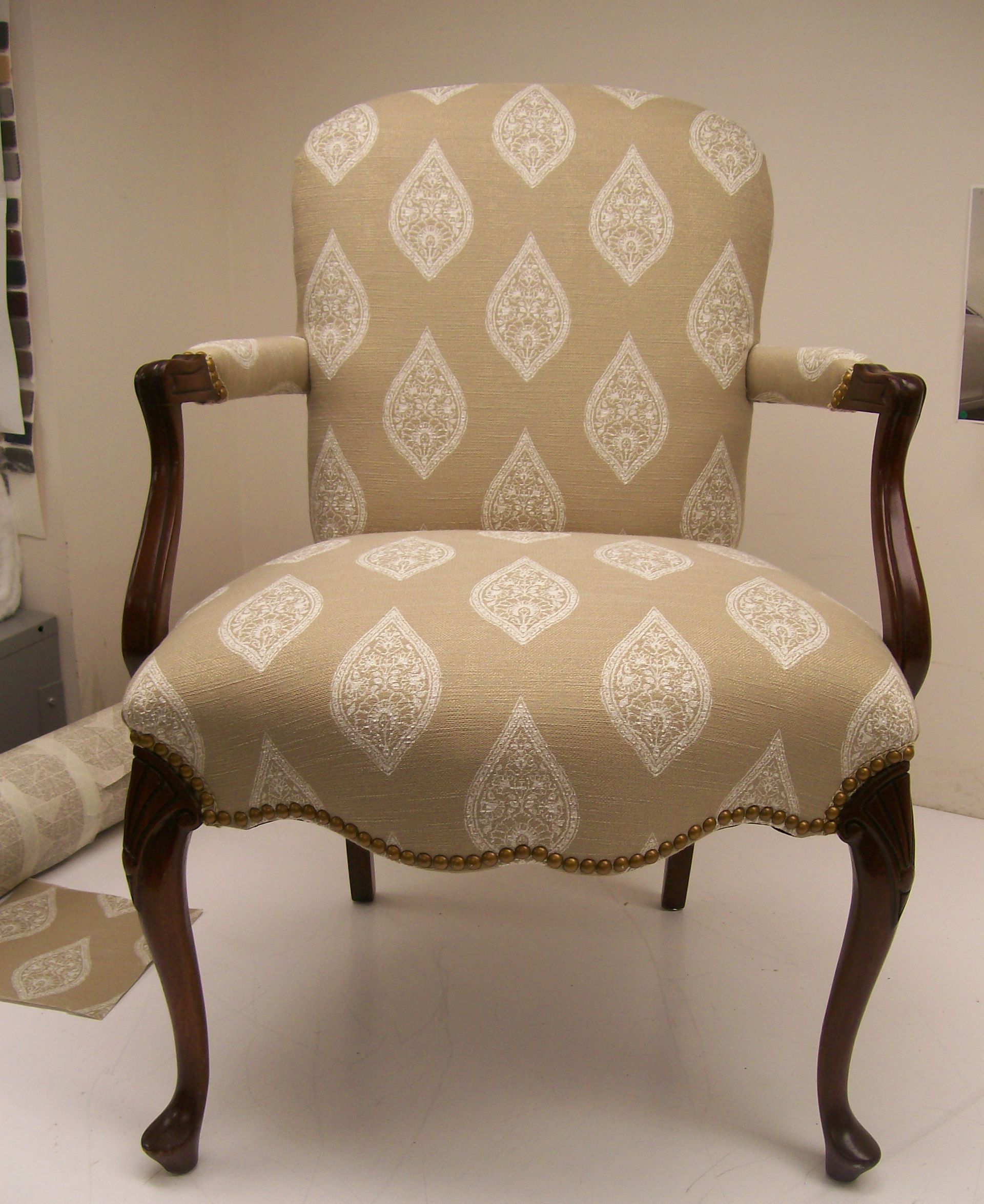 A chair with a pattern of leaves on it