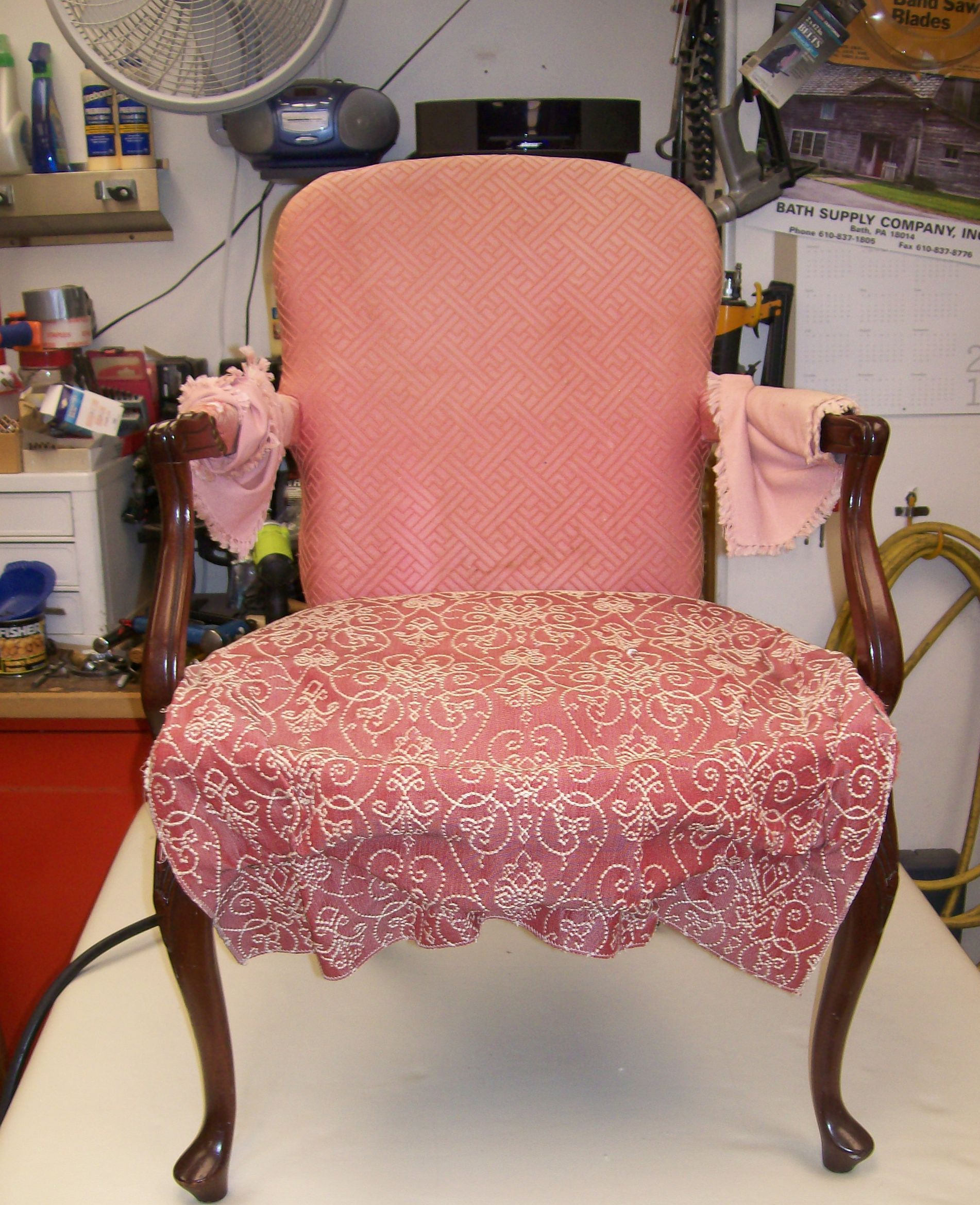 A pink chair is sitting on a table in a room