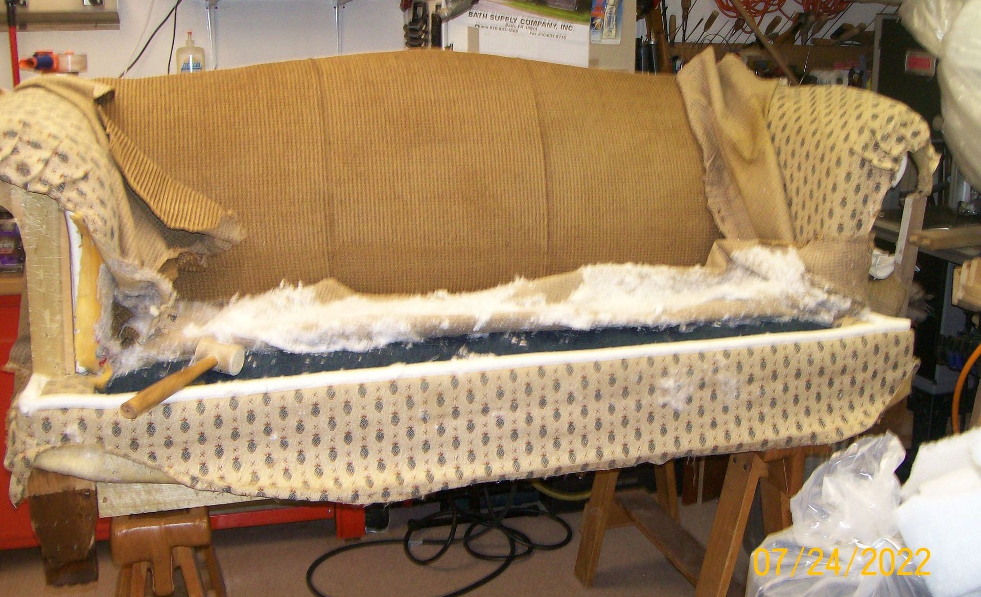 A couch is sitting on a wooden table in a room