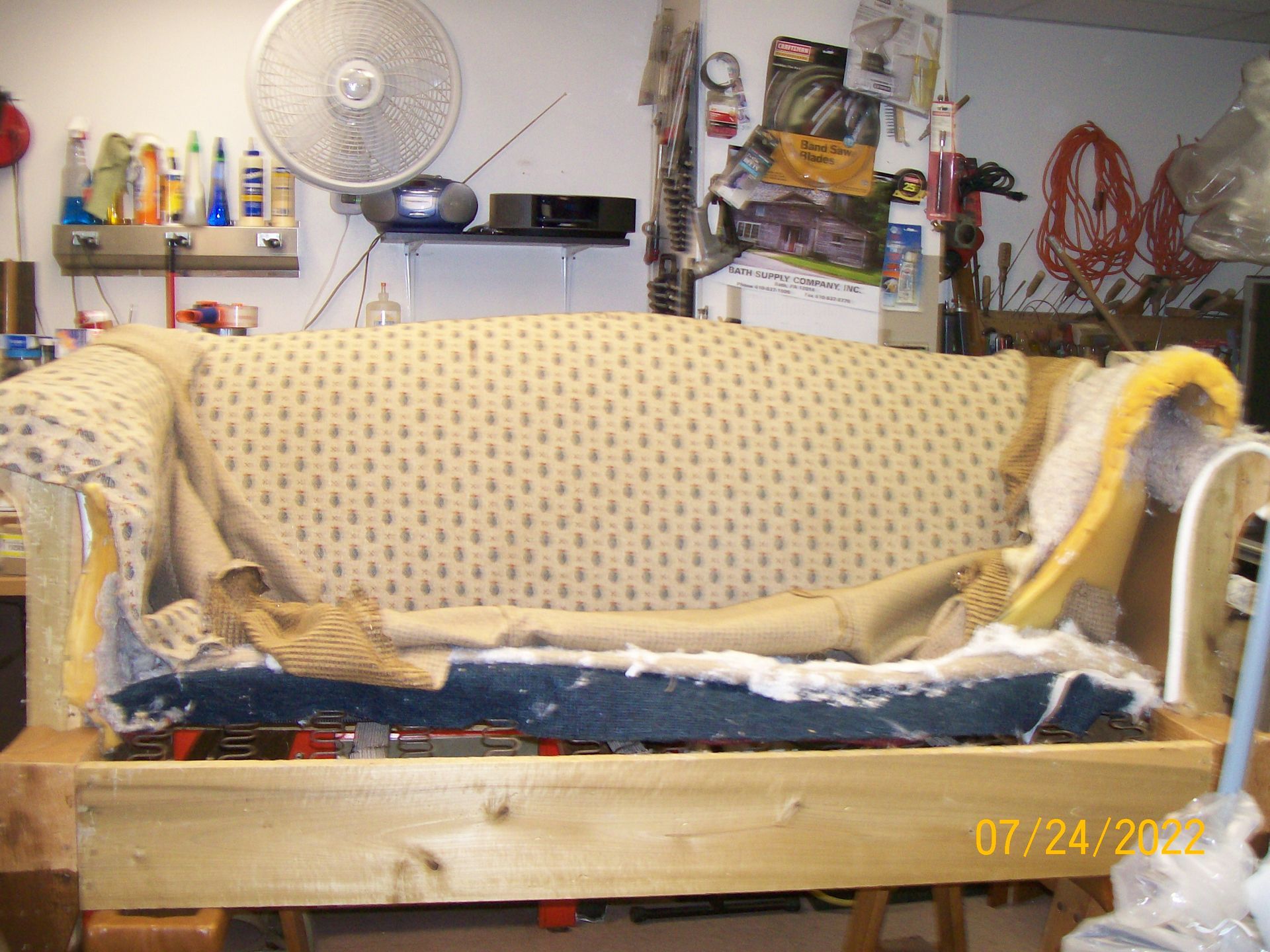 A picture of a couch being repaired