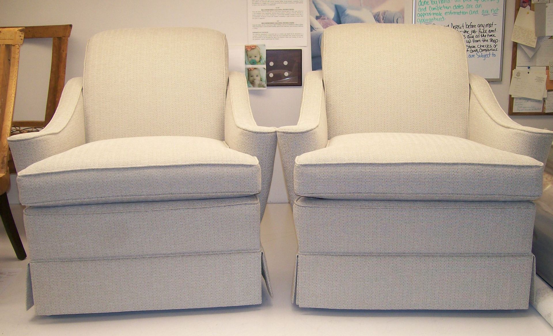Two white chairs are sitting next to each other on a table