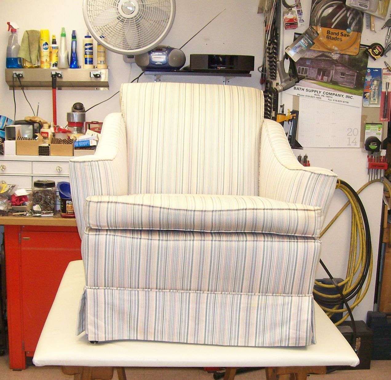 A striped chair is sitting on a white table