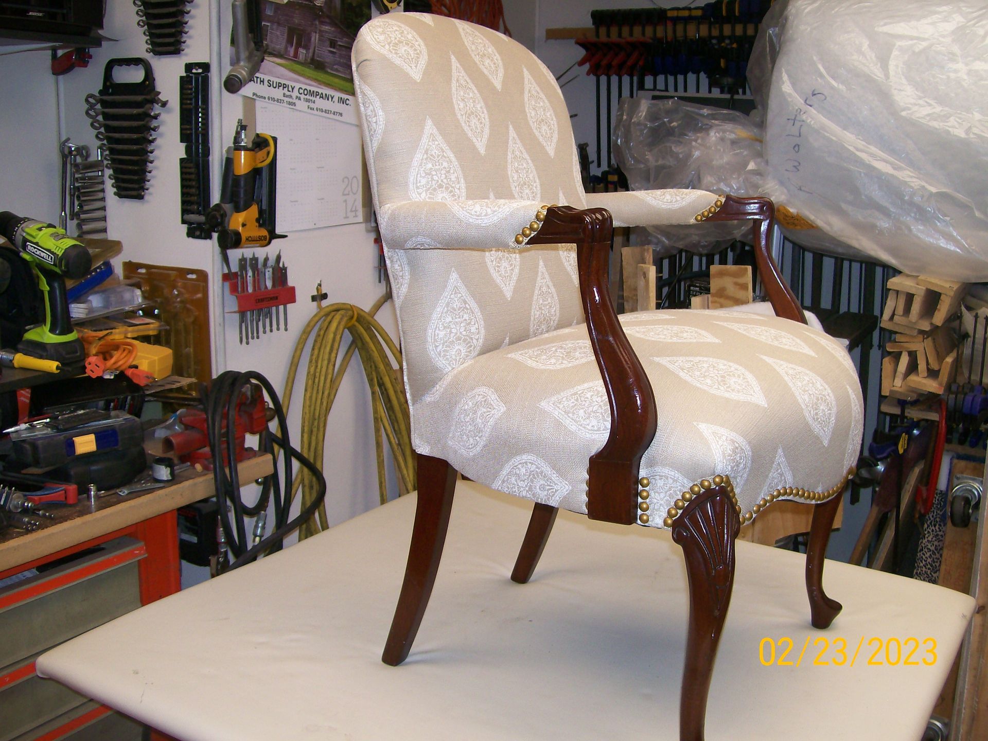 A chair is sitting on top of a table in a workshop