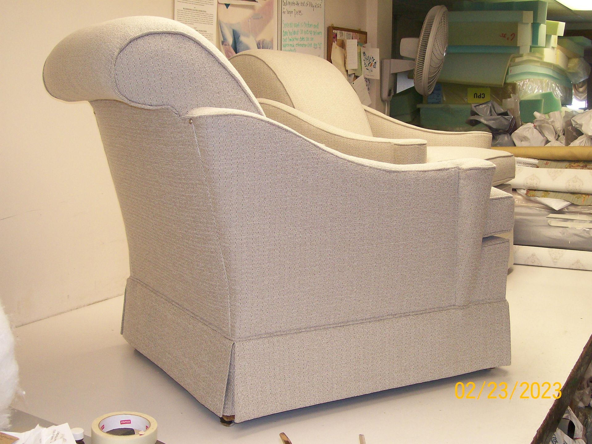 A chair is sitting on a table with a roll of tape on it